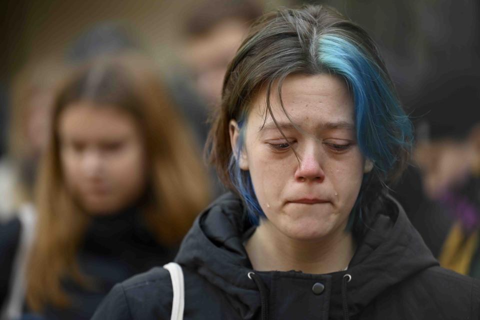 A woman cries outside the headquarters of Charles University for victims of mass shooting in Prague, Czech Republic, Friday, Dec. 22, 2023. A lone gunman opened fire at a university on Thursday, killing more than a dozen people and injuring scores of people. (AP Photo/Denes Erdos)