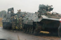 Soldiers stand beside military vehicles just outside Harare, Zimbabwe, November 14, 2017. REUTERS/Philimon Bulawayo