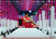 LONDON, ENGLAND - AUGUST 07: Xiang Liu of China sits on the track after getting injured in the Men's 110m Hurdles Round 1 Heats on Day 11 of the London 2012 Olympic Games at Olympic Stadium on August 7, 2012 in London, England. (Photo by Stu Forster/Getty Images)