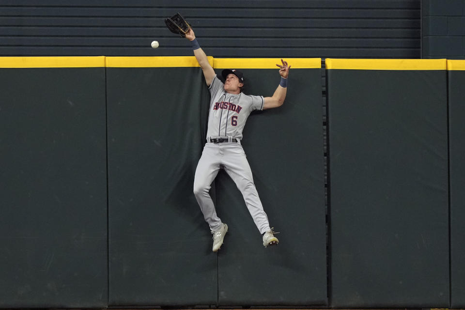 Houston Astros center fielder Jake Meyers (6) cannot reach the solo home run by Texas Rangers' Jonah Heim during the fourth inning of a baseball game in Arlington, Texas, Friday, June 30, 2023. (AP Photo/LM Otero)