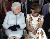 FILE - Britain's Queen Elizabeth sits next to Vogue fashion editor Anna Wintour as they view Richard Quinn's runway show before presenting him with the inaugural Queen Elizabeth II Award for British Design in central London on Feb. 20, 2018. (Yui Mok/Pool photo via AP)