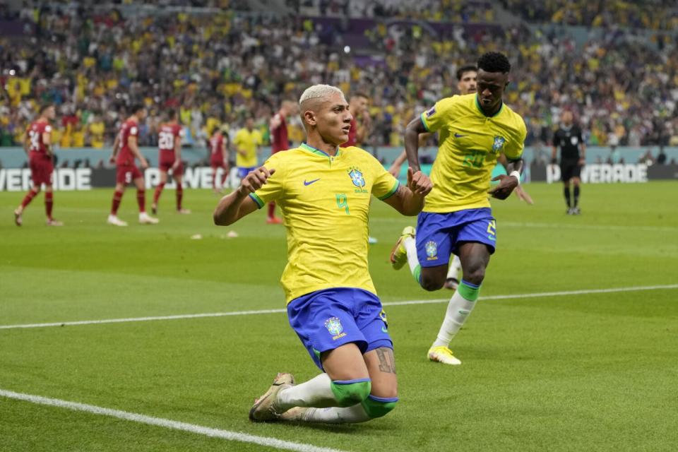 Brazil's Richarlison slides as he celebrates after scoring against Serbia on Thursday.