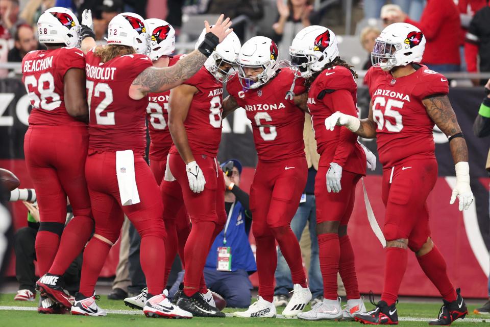 James Conner #6 of the Arizona Cardinals celebrates with teammates after a rushing touchdown during the third quarter against the Seattle Seahawks at State Farm Stadium on Jan. 7, 2024, in Glendale.