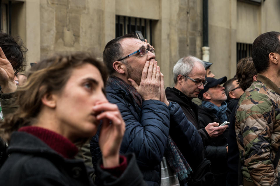 People watch the landmark Notre-Dame Cathedral burning in central Paris on April 15, 2019. (Photo: Nicolas Liponne/NurPhoto via Getty Images)