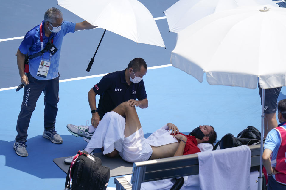 Daniil Medvedev, of the Russian Olympic Committee, is tended to during a third round men's tennis match against Fabio Fognini, of Italy, at the 2020 Summer Olympics, Wednesday, July 28, 2021, in Tokyo, Japan. (AP Photo/Patrick Semansky)