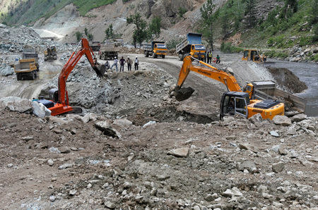 FILE PHOTO: Excavators are used to dig earth at the dam site of Kishanganga power project in Gurez, 160 km (99 miles) north of Srinagar June 21, 2012. REUTERS/Fayaz Kabli/File Photo