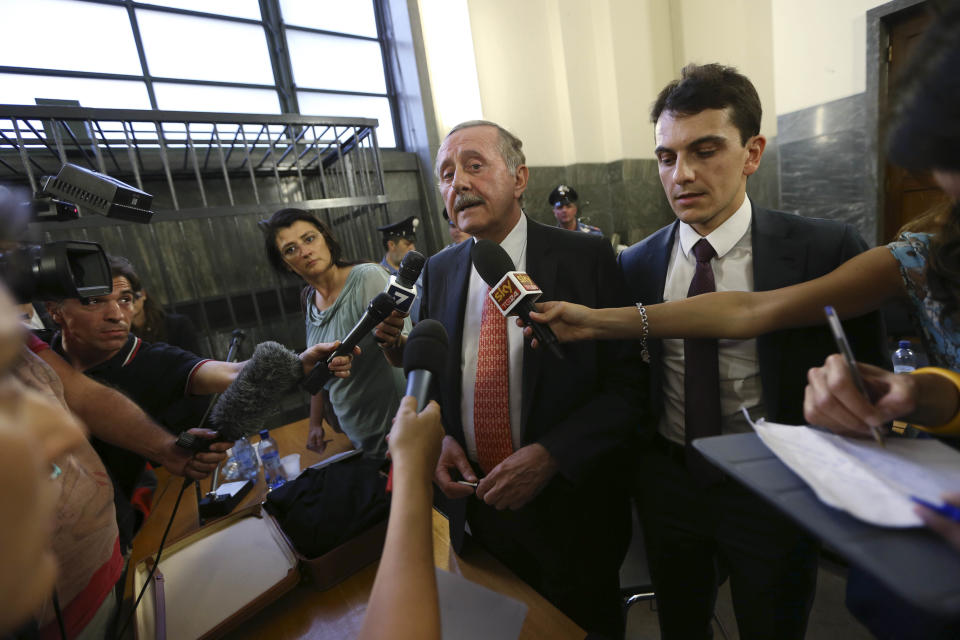 Italian fashion designers Domenico Dolce and Stefano Gabbana lawyer Massimo Di Noia answers reporters' questions after the sentence at the Milan's court, Italy, Wednesday, June 19, 2013. A Milan court convicted fashion designers Domenico Dolce and Stefano Gabbana of tax evasion. The pair were found guilty Wednesday of failing to declare euros 1 billion ($1.3 billion) in income to authorities. The court sentenced them both to one year and eight months in jail. Prosecutors argued that the pair had evaded taxes on income of 416 million euros each and 200 million euros through a Luxembourg-based company. The statute of limitations ran out on a charge of misrepresenting income. (AP Photo/Luca Bruno)