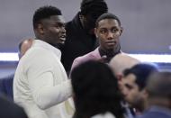 Duke's Zion Williamson, left, and RJ Barrett speak before the NBA basketball draft Thursday, June 20, 2019, in New York. (AP Photo/Julio Cortez)