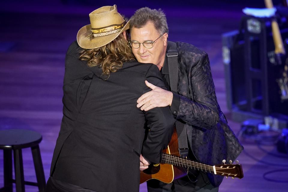 Chris Stapleton, left, accepts the Spirit Award from Vince Gill during the 15th Annual Academy Of Country Music Honors at Ryman Auditorium in Nashville, Tenn., Wednesday, Aug. 24, 2022.