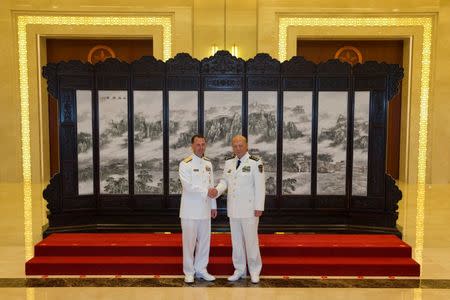 Commander of the Chinese navy, Admiral Wu Shengli (R) shakes hands with U.S. Chief of Naval Operations Admiral John Richardson during a welcome ceremony held at the Chinese Navy Headquarters in Beijing, China, July 18, 2016. REUTERS/Ng Han Guan/Pool