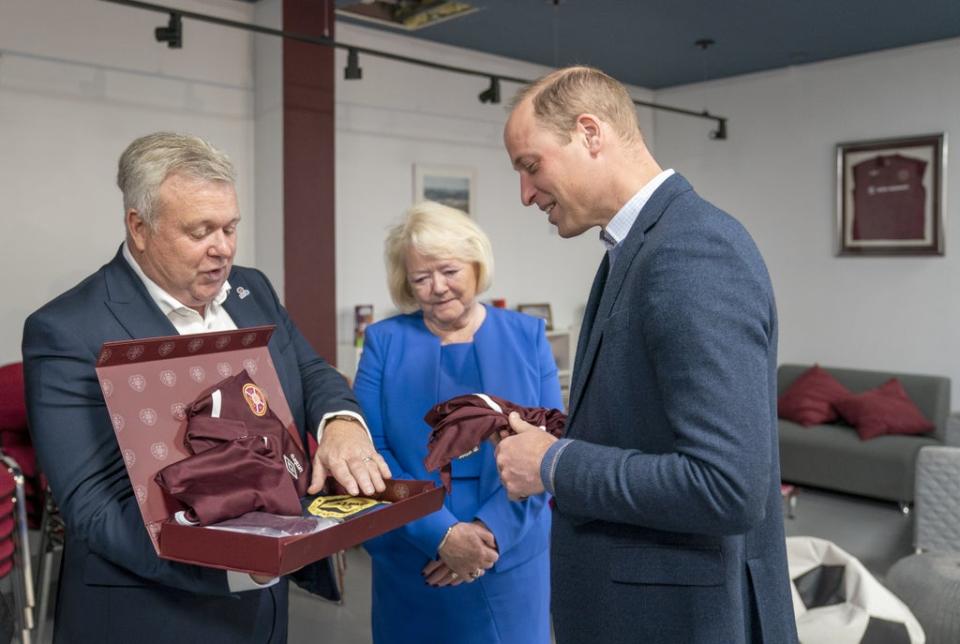 Delighted Prince William accepted the gifts from Chief Executive Andrew McKinlay and Chair Ann Budge (PA)