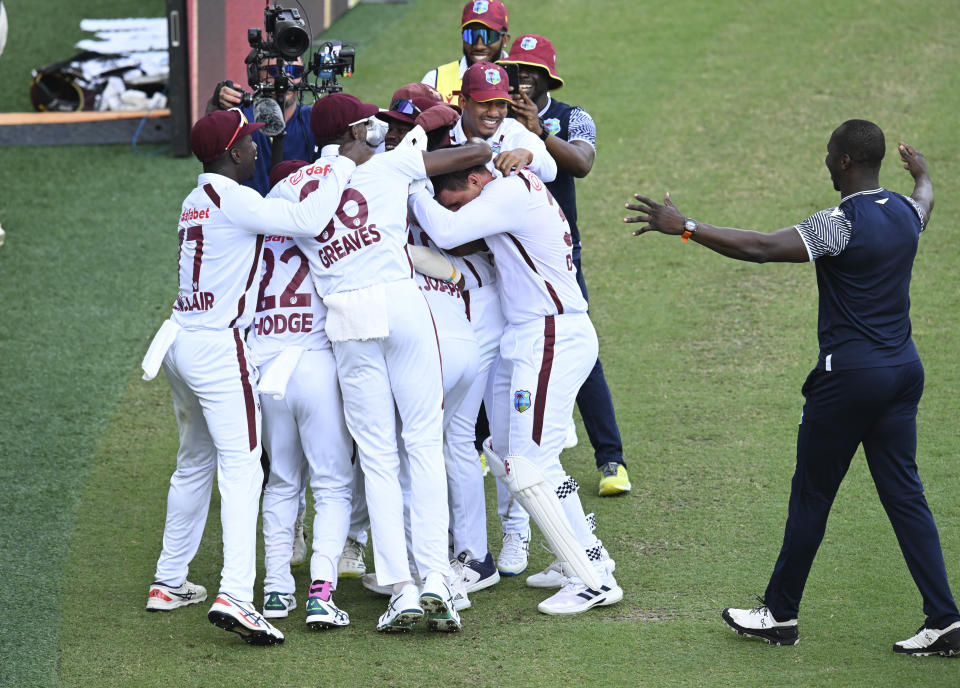 West Indies players celebrate after defeating Australia on the 4th day of their cricket test match in Brisbane, Sunday, Jan. 28, 2024. (Darren England/AAP Image via AP)