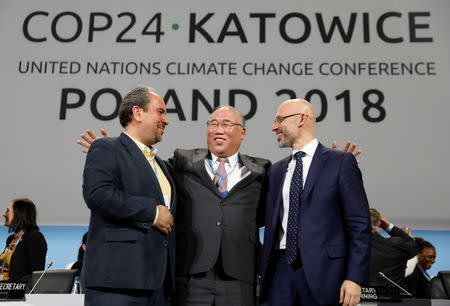 Iran's head of delegation Majid Shafiepour Motlagh, China's head of delegation Xie Zhenhua and COP24 President Michal Kurtyka smile after adopting the final agreement during a closing session of the COP24 U.N. Climate Change Conference 2018 in Katowice, Poland, December 15, 2018. REUTERS/Kacper Pempel