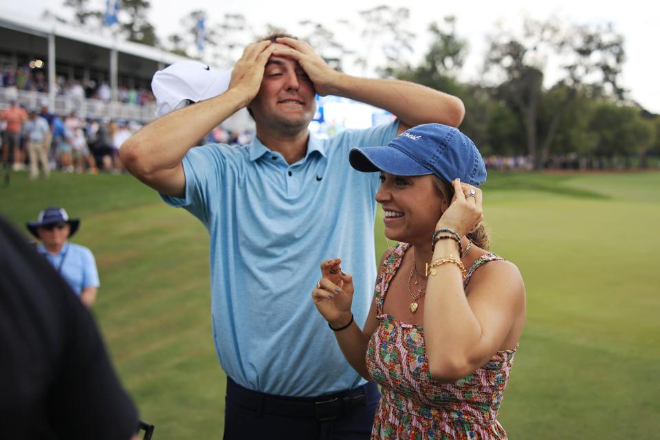 Scottie Scheffler reacts with his wife Meredith Scudder on hole 18 after winning the tournament during the fourth and final round of The Players golf tournament Sunday, March 12, 2023 at TPC Sawgrass in Ponte Vedra Beach, Fla. Scottie Scheffler of Dallas won the tournament at 17 under par with Tyrell Hatton at 12 under par as runner-up. [Corey Perrine/Florida Times-Union]