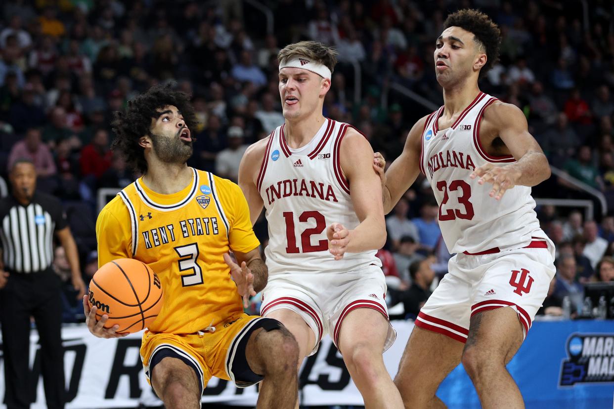 ALBANY, NEW YORK - MARCH 17: Sincere Carry #3 of the Kent State Golden Flashes handles the ball against Miller Kopp #12 and Trayce Jackson-Davis #23 of the Indiana Hoosiers in the second half during the first round of the NCAA Men's Basketball Tournament at MVP Arena on March 17, 2023 in Albany, New York.