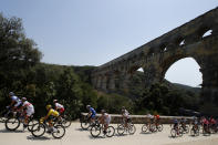 The pack rides next to the Pont du Gard during the sixteenth stage of the Tour de France cycling race over 117 kilometers (73 miles) with start and finish in Nimes, France, Tuesday, July 23, 2019. (AP Photo/ Christophe Ena)