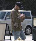 <p>NRL star Nate was being a doting dad cradling his precious new child.</p>