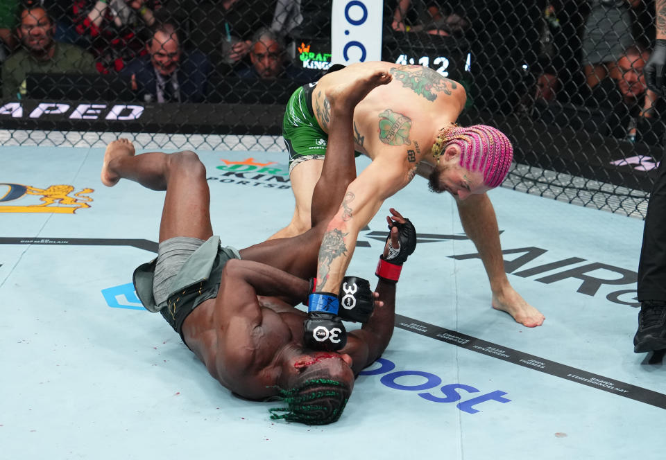 BOSTON, MASSACHUSETTS - AUGUST 19: (R-L) Sean O'Malley knocks out Aljamain Sterling in the UFC bantamweight championship fight during the UFC 292 event at TD Garden on August 19, 2023 in Boston, Massachusetts. (Photo by Cooper Neill/Zuffa LLC via Getty Images)