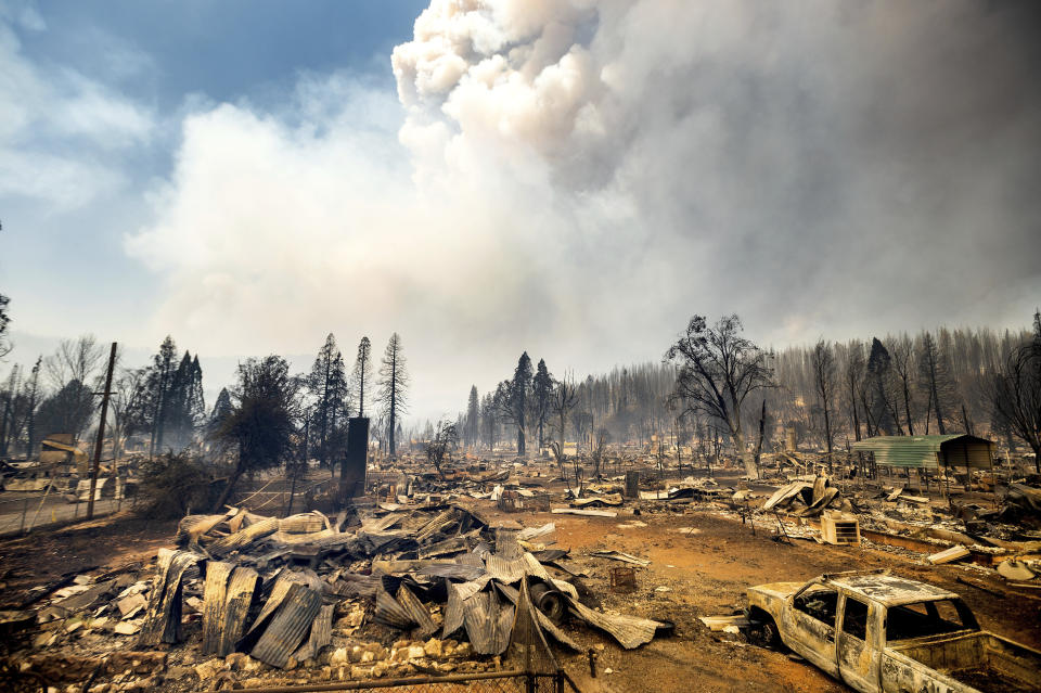 This photo shows cars and homes destroyed by the Dixie Fire line central Greenville on Thursday, Aug. 5, 2021, in Plumas County, Calif. (AP Photo/Noah Berger)