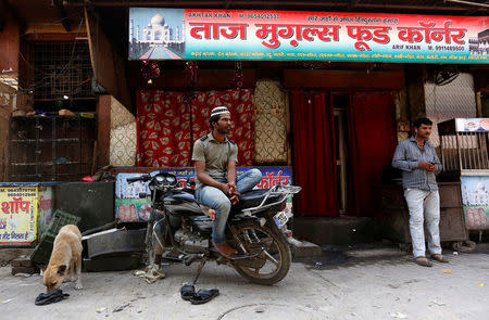 A muslim looks on outside a closed restaurant in Gurugram, Haryana, India March 29, 2017. REUTERS/Cathal McNaughton