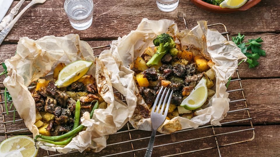 Traditional Greek kleftiko, an oven-baked lamb stew with potato, olive oil, onion, carrot, garlic and herbs, served with lemon and ouzo - fazeful/iStockphoto/Getty Images