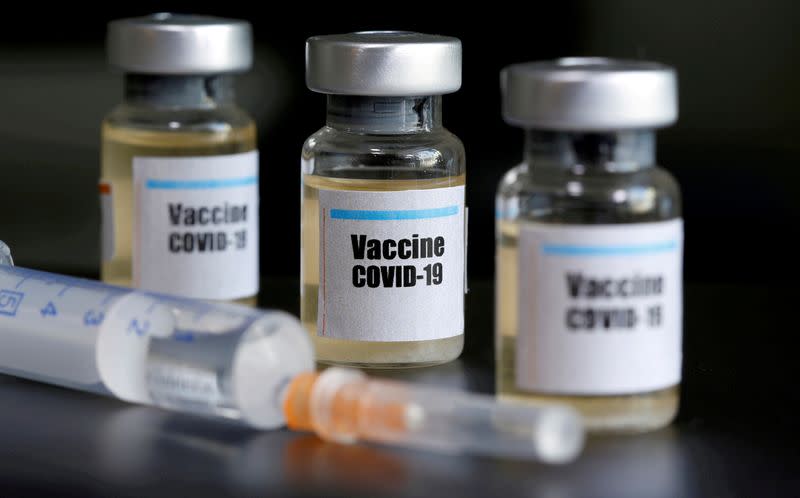 ushFILE PHOTO: Small bottles labeled with a "Vaccine COVID-19" sticker and a medical syringe are seen in this illustration