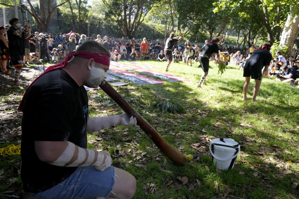 Aboriginal man Arron Nichols, left, plays a didgeridoo as other members of the Muggera Dancers perform at the start of an Invasion Day rally in Sydney, Thursday, Jan. 26, 2023. Australia is marking the anniversary of British colonists settling modern day Sydney in 1788 while Indigenous protesters deride Australia Day as Invasion Day. (AP Photo/Rick Rycroft)