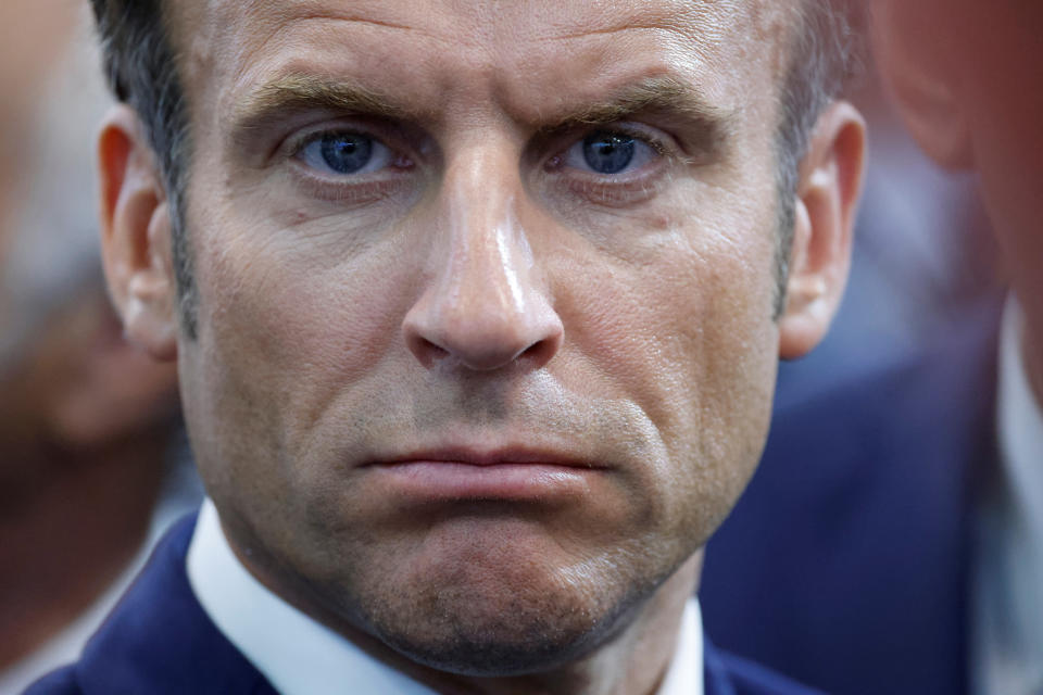 FILE - French President Emmanuel Macron looks on as he visits the Eurosatory land and airland defense and security trade fair, in Villepinte, north of Paris, June 13, 2022. Emmanuel Macron is badly weakened at home after parliamentary elections cost his party its majority - but his domestic headaches look unlikely to clip his wings on the world stage or threaten his international agenda. (Ludovic Marin, Pool via AP, File)