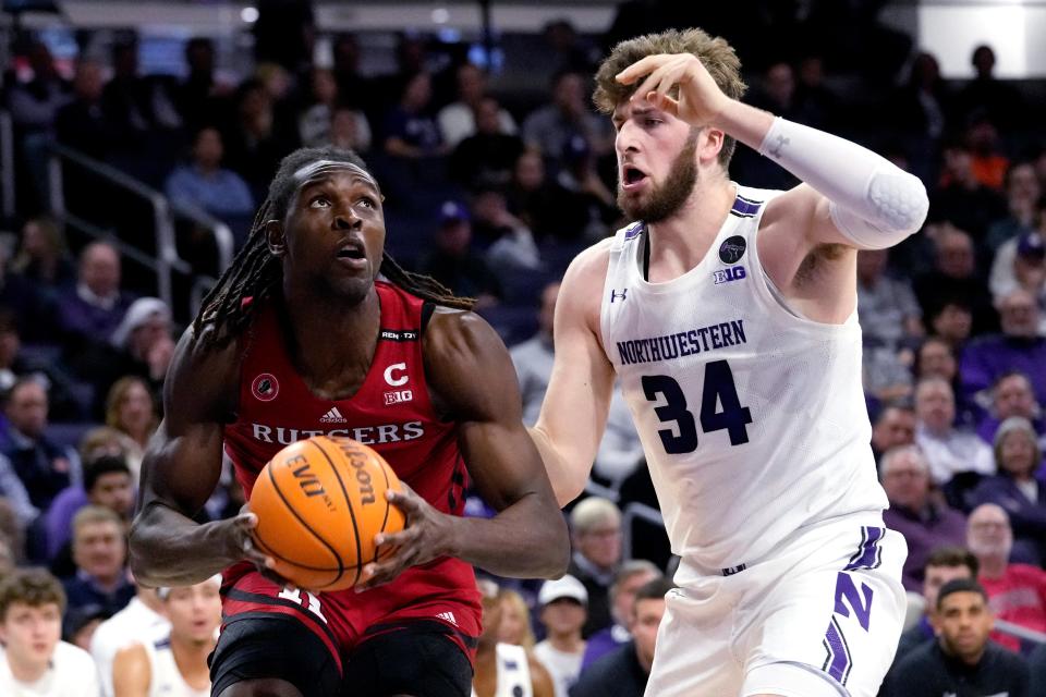 Rutgers center Clifford Omoruyi, left, looks at the basket as Northwestern center Matthew Nicholson guards during the first half