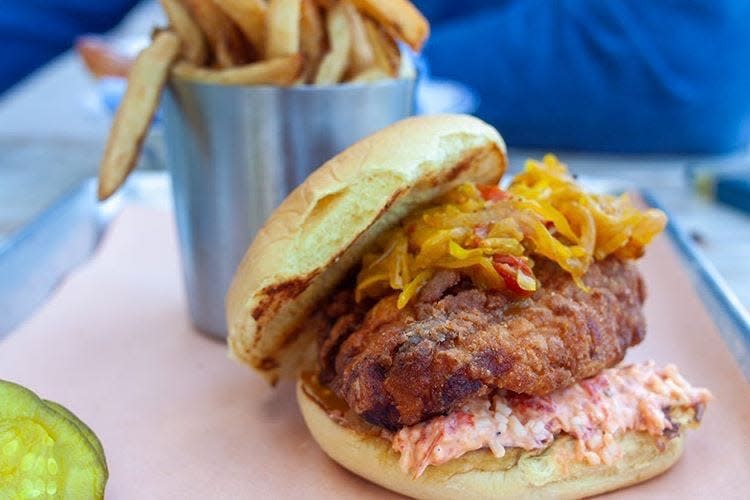 At Sassafras, the crispy fried chicken sandwich is served with a smear of pimento cheese and chow chow.