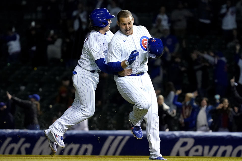 Chicago Cubs' Tony Wolters, left, congratulates Anthony Rizzo, who drove in the winning run in the 11th inning of a baseball game against the Los Angeles Dodgers in Chicago, Wednesday, May 5, 2021. The Cubs won 6-5. (AP Photo/Nam Y. Huh)