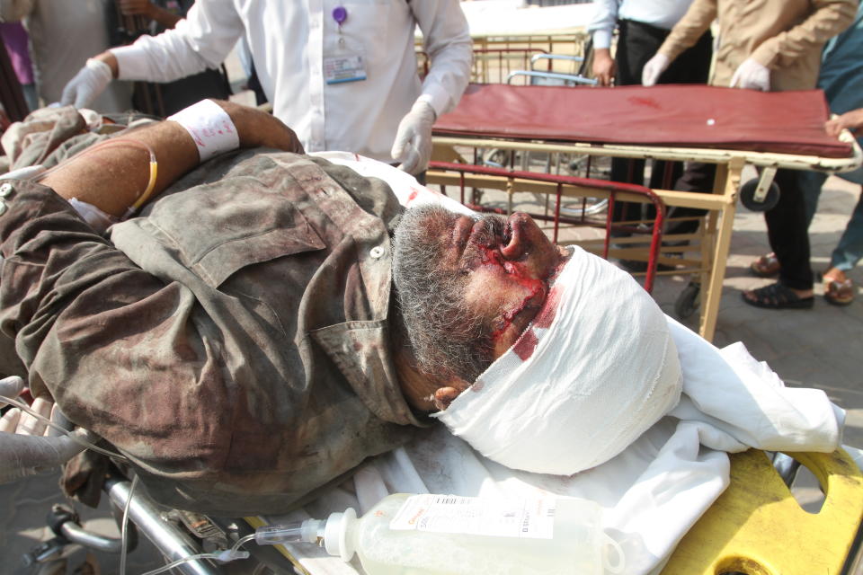 A man injured in a train fire arrives at a hospital for treatment in Multan, Pakistan, Thursday, Oct. 31, 2019. A massive fire engulfed three carriages of the train traveling in the country's eastern Punjab province (AP Photo/Asim Tanveer)