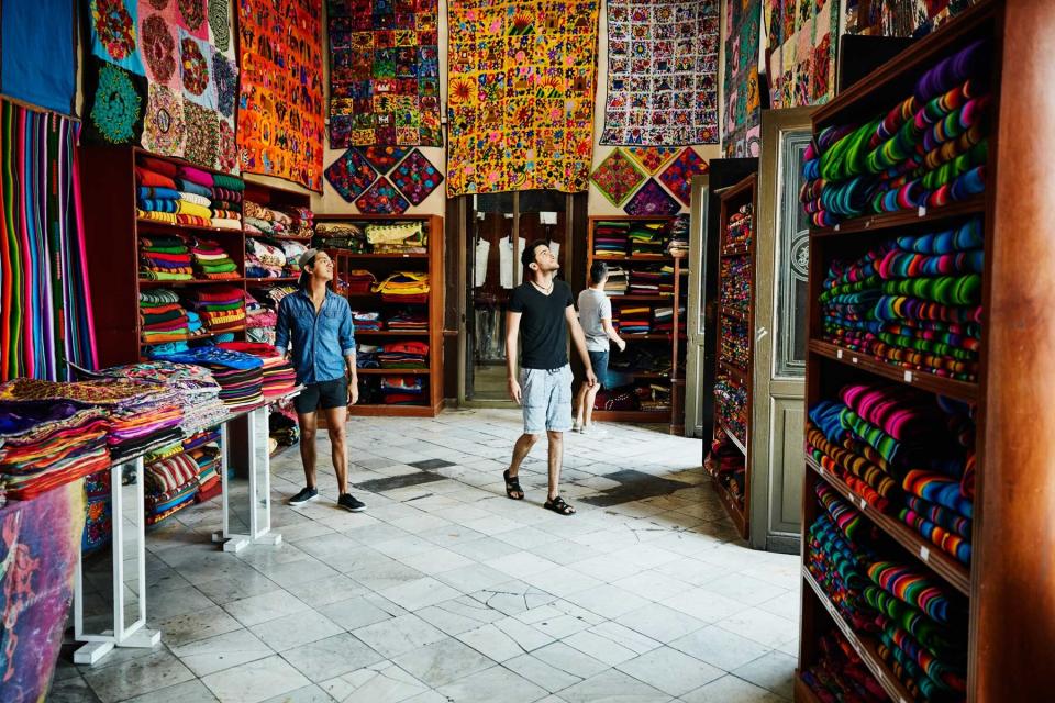 Friends exploring a shop in a market in Merida, Mexico