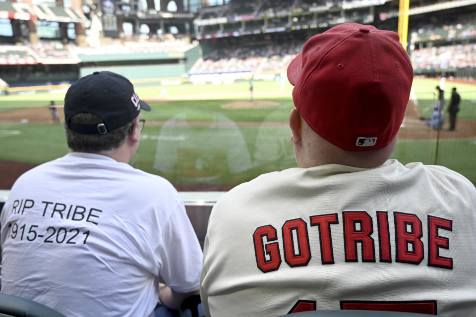 Chuck Hanus, left, from Orlando Fla., and Michael Bell, from Las Vegas, watch a baseball game between the Cleveland Indians and the Texas Rangers in Arlington Texas, Sunday, Oct. 3, 2021. Both men flew to Texas for the final Indians game before the team's name change. (AP Photo/Matt Strasen)