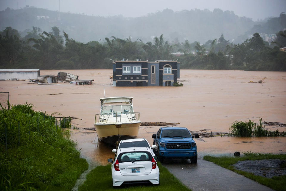 People inside a house await rescue from the floods caused by Hurricane Fiona in Cayey, Puerto Rico, on Sept. 18, 2022. (Stephanie Rojas / AP)