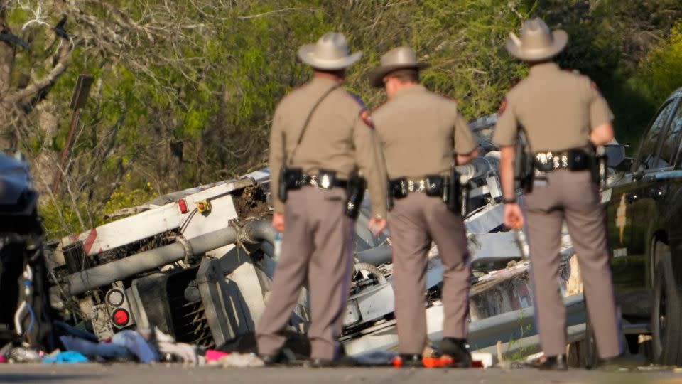 State troopers look at a vehicle involved in the crash. - Jay Janner/American-Statesman/USA Today