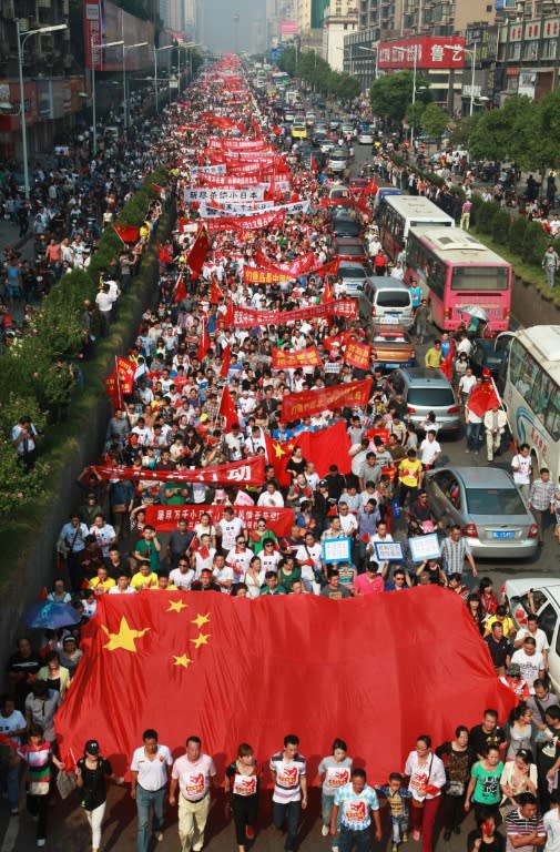 Chinese demonstrators march with Chinese national flags and banners during a protest against Japan's "nationalizing" of Diaoyu Islands, also known as Senkaku in Japan, in Hengyang, central China's Hunan province, on Septermber 18, 2012