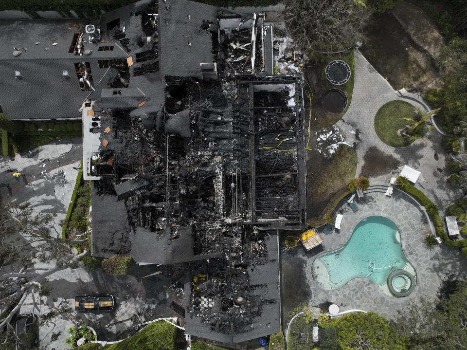 An aerial view shows a fire-damaged property, which appears to belong to Cara Delevingne, Friday, March 15, 2024, in the Studio City section of Los Angeles. (AP Photo/Jae C. Hong)