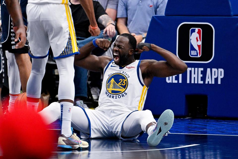 March 22: The Golden State Warriors' Draymond Green celebrates after making a basket and drawing a foul against the Dallas Mavericks during the second half at the American Airlines Center. The Warriors won the game, 127-125.