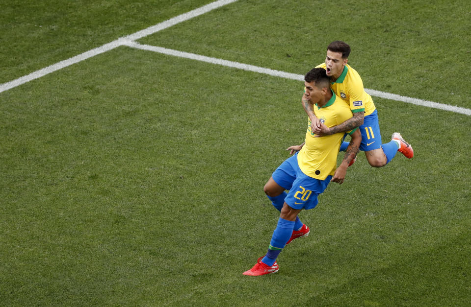 Brazil's Roberto Firmino celebrates scoring his side's second goal with teammate Phlippe Coutinho during a Copa America Group A soccer match against Peru at the Arena Corinthians in Sao Paulo, Brazil, Saturday, June 22, 2019. (AP Photo/Nelson Antoine)