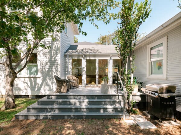 A new porch sits off the connective family room. Haden had previously built a deck on the property, which the design team disassembled. They then used the boards to construct the new outdoor space.