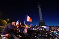 <p>Motorists and bystanders wave flags as they celebrate France’s victory at Bastille in Paris on July 10, 2018, after the final whistle of the Russia 2018 World Cup semi-final football match between France and Belgium. (Photo by Thomas SAMSON / AFP) </p>