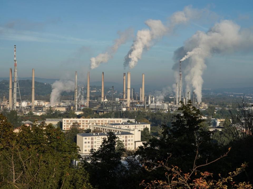 Smoke rises from the Feyzin Total refinery chimneys outside Lyon, central France, on Oct. 15. (Laurent Cipriani/The Associated Press - image credit)