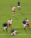 Delight on the faces of the Tonga players is beautifully captured by David Ramos (World Rugby via Getty Images) from an elevated position, using the EF 70 - 200mm f/2.8L IS III USM lens. France edged a compelling contest 23 - 21.