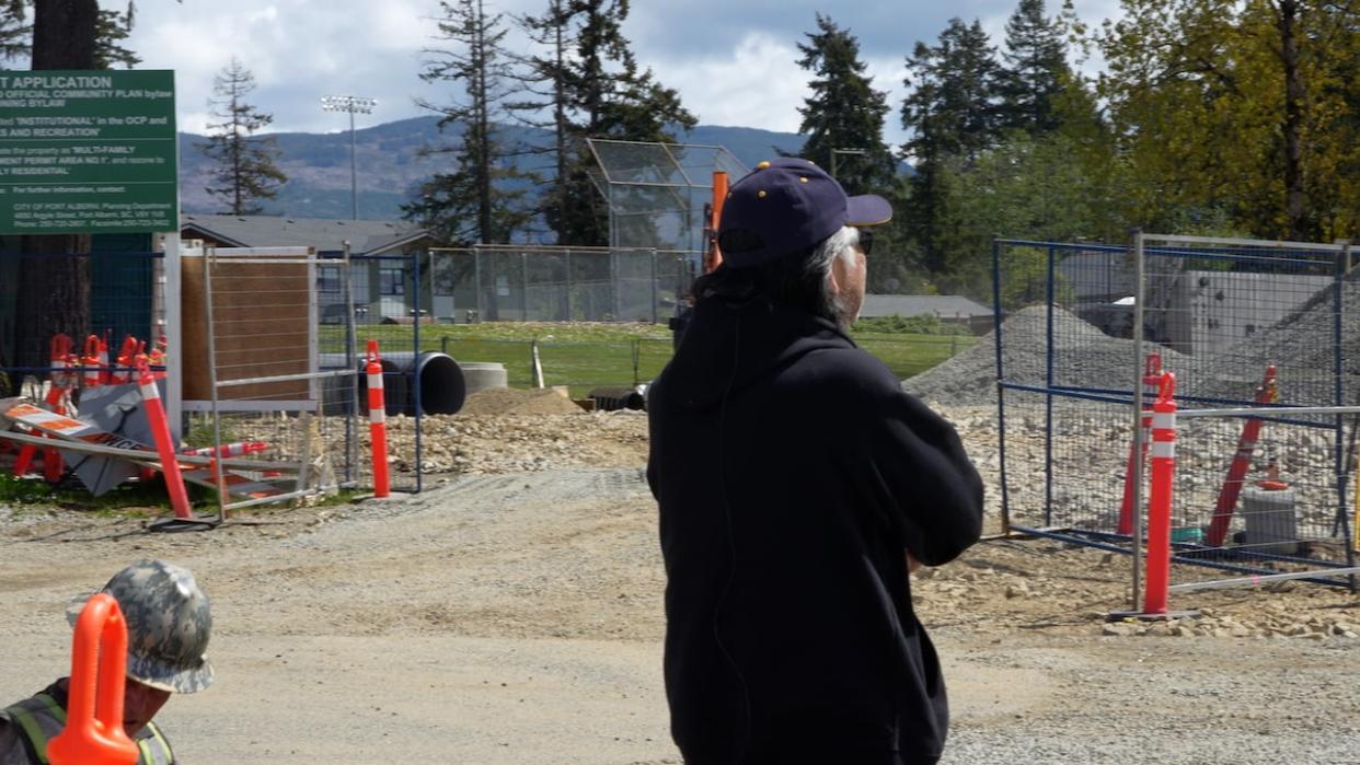 Wally Samuel, an Ahousaht elder and chair of the Citaapi Mahtii Housing Society, looks out over the site of a future development in Port Alberni, B.C., that will house 35 Ahousaht families.  (Claire Palmer/CBC News - image credit)