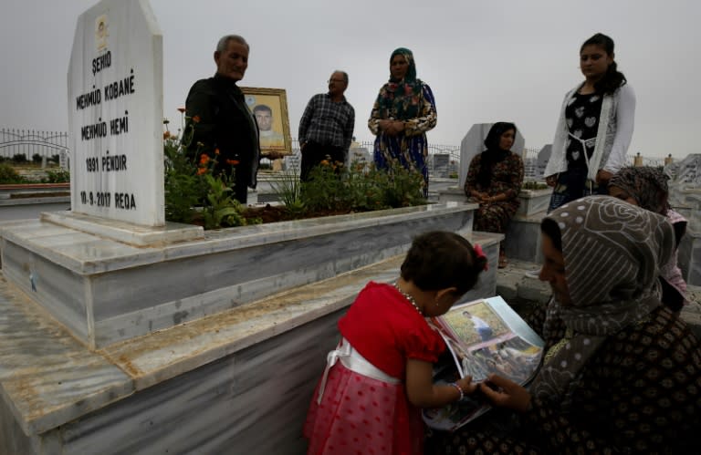 Syrian Kurds visit graves of loved ones at the Martyrs' Cemetery in the northern town of Kobane on May 28, 2018