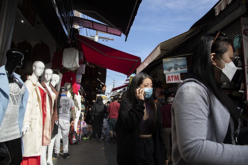 LOS ANGELES, CA - DECEMBER 20: Santee Alley was busy with shoppers on Monday, Dec. 20, 2021. Health officials are warning of a possible winter COVID surge with the Omicron variant. (Myung J. Chun / Los Angeles Times)