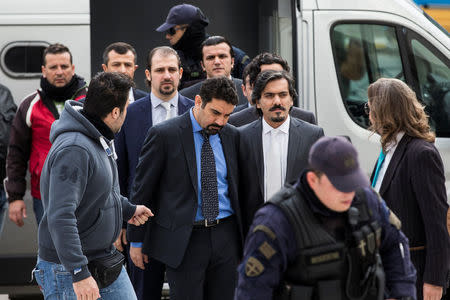 The eight Turkish soldiers, who fled to Greece in a helicopter and requested political asylum after a failed military coup against the government, are escorted by police officers as they arrive at the Supreme Court in Athens, Greece, January 26, 2017. REUTERS/Alkis Konstantinidis