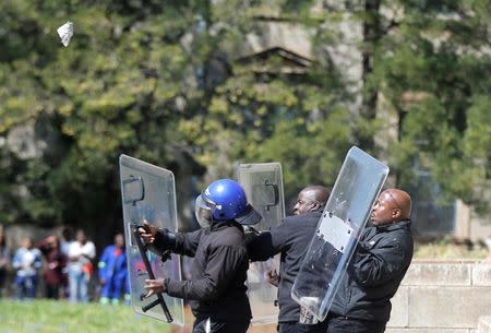 Students throw stones during clashes with security at Johannesburg's University of the Witwatersrand in Johannesburg. REUTERS/Siphiwe Sibeko