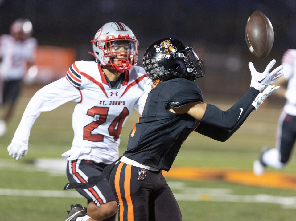 Massillon receiver Braylyn Toles catches a first-quarter pass in front of St. John's Roman Richardson, Friday Sept. 29, 2023.
